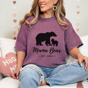 Momma Bear t-shirt with baby bear graphic and customizable “Est.” year on a purple oversized tee