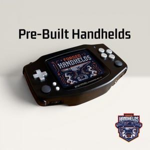 May include: A black handheld gaming console with silver buttons and a directional pad. The screen displays the text FORGED HANDHELD with an anvil graphic and the text BOXYPIXEL POWERED BY PI. The text Pre-Built Handhelds appears above the console.
