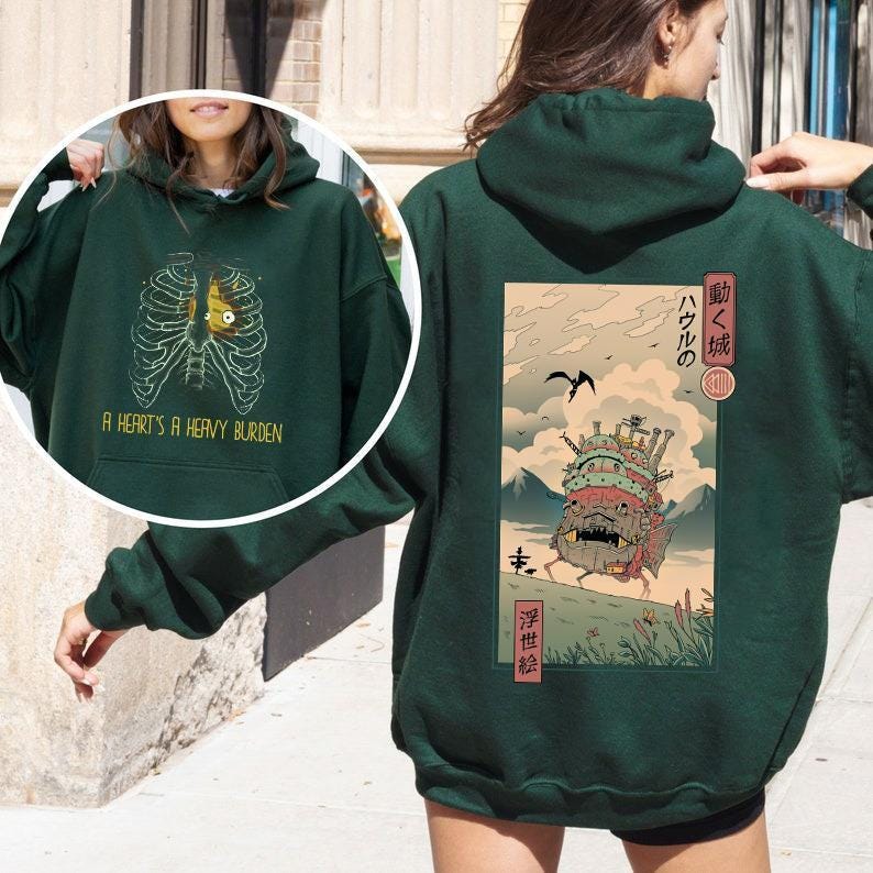 a woman wearing a green hoodie with a picture of a dragon on it