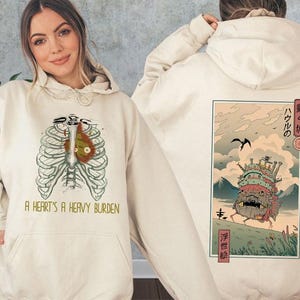 a woman wearing a hoodie with a japanese painting on it