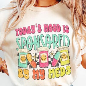 a woman wearing a t - shirt that says today's hood is sponsored by