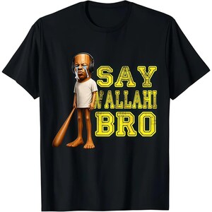 May include: Black t-shirt featuring a cartoon character with headphones and tears, holding a baseball bat. The text "SAY WALLAHI BRO" is printed in yellow, outlined in black.