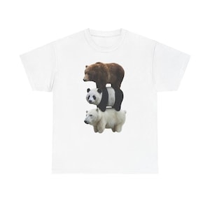 May include: White t-shirt featuring a whimsical design of three bears stacked on top of each other. The bears include a brown bear, a panda bear, and a white bear. The design is centered on the front of the shirt.