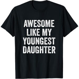 May include: Black t-shirt with the white text "AWESOME LIKE MY YOUNGEST DAUGHTER". The shirt has short sleeves and a crew neck. The text is in a bold, sans-serif font.