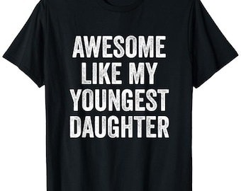 May include: Black t-shirt with the white text "AWESOME LIKE MY YOUNGEST DAUGHTER". The shirt has short sleeves and a crew neck. The text is in a bold, sans-serif font.