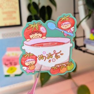 Cute illustrated sticker of tomato fairies making a big, warming bowl of tomato soup!