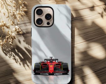 May include: A smartphone case featuring a red Formula 1 race car design. The case has a light gray background and a glossy finish. The race car is detailed with black and yellow accents.