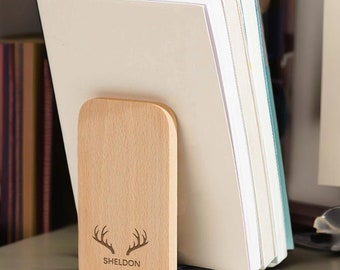 May include: Wooden bookends with a natural finish and a carved design of antlers and the name "SHELDON".