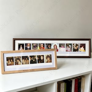 May include: Two rectangular photo frames with white matting, one with a dark brown finish and one with a light wood finish. Each frame displays a horizontal series of individual square photographs. The light wood frame features the text Unchanging Friendship.