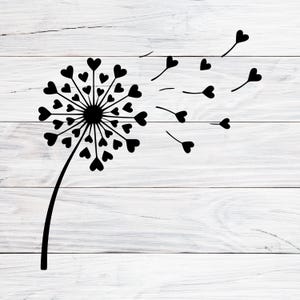 Può includere: Un disegno di dente di leone nero con semi a forma di cuore che soffiano nel vento. Il dente di leone è centrato, con uno stelo curvo e semi che si disperdono verso destra. Lo sfondo è una superficie di assi di legno bianche.