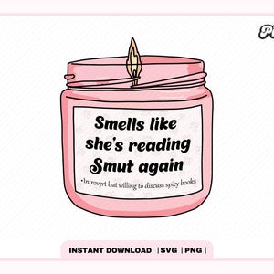 May include: A pink candle with a flame on top and a label that reads "Smells like she's reading Smut again. Introvert but willing to discuss spicy books."