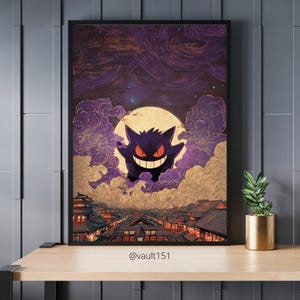 May include: Framed art print depicting a purple cartoon character with a wide grin against a full moon and cloudy sky. The artwork has a Japanese aesthetic, with a cityscape below. The print is displayed on a wooden surface.