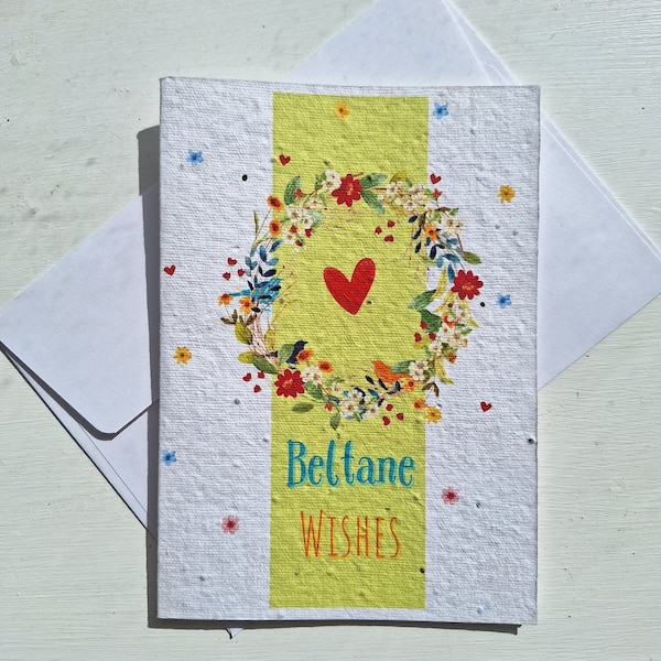 An A6 Beltane May day celebrations seed card that can be planted after use. Depicts a flower door wreath with springtime flowers and hearts.