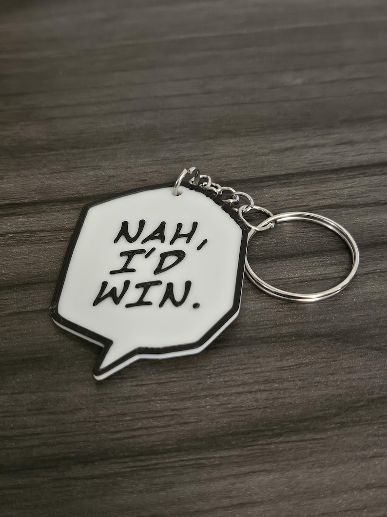 May include: White keychain with a black speech bubble that says "NAH, I'D WIN."