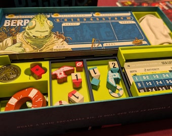 May include: A board game box containing a player board with a green creature illustration, a gold coin, red and white wooden tokens, numbered cubes, and a reference card titled Angler's Guide to Sea Life with a difficulty chart and depth levels.