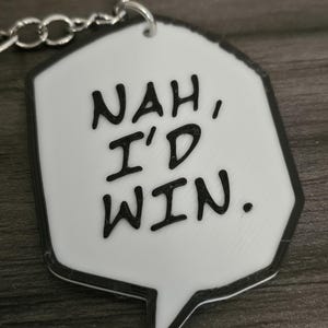 May include: White keychain with a black outline in the shape of a speech bubble. The text inside the bubble reads "NAH, I'D WIN."
