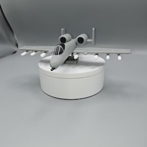 May include: A set of three ceramic mugs with a speckled, matte finish. The mugs are in shades of cream, light gray, and dark gray. Each mug has a simple, minimalist design, perfect for coffee or tea.