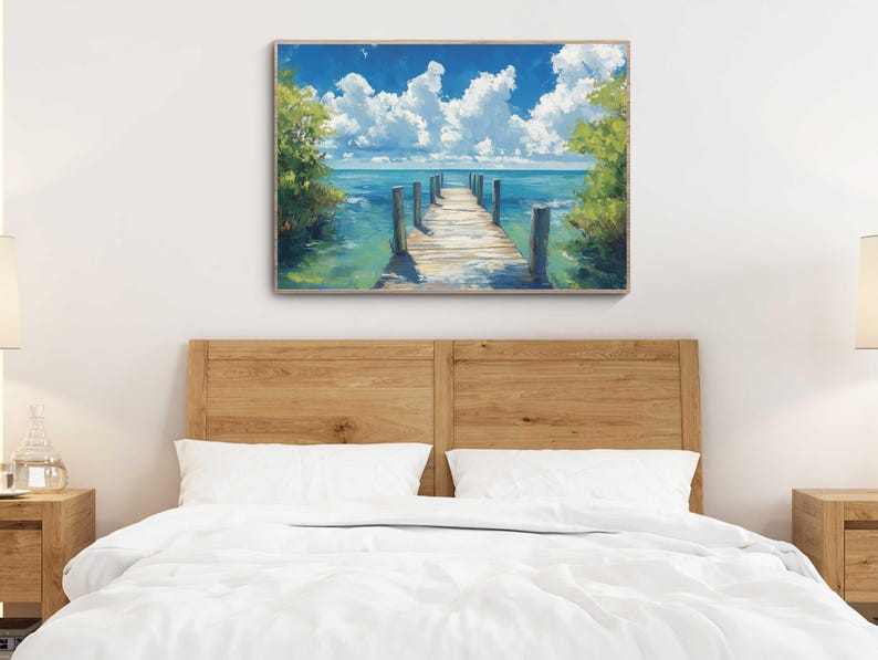 a bed with a white comforter and a painting on the wall