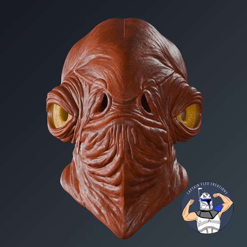 Puede incluir: Una m&aacute;scara detallada de color marr&oacute;n rojizo con grandes ojos amarillos y una superficie texturizada. La m&aacute;scara presenta prominentes crestas faciales y cuencas de los ojos, con un dise&ntilde;o que recuerda a un personaje de ficci&oacute;n. La m&aacute;scara es probablemente para cosplay o exhibici&oacute;n.