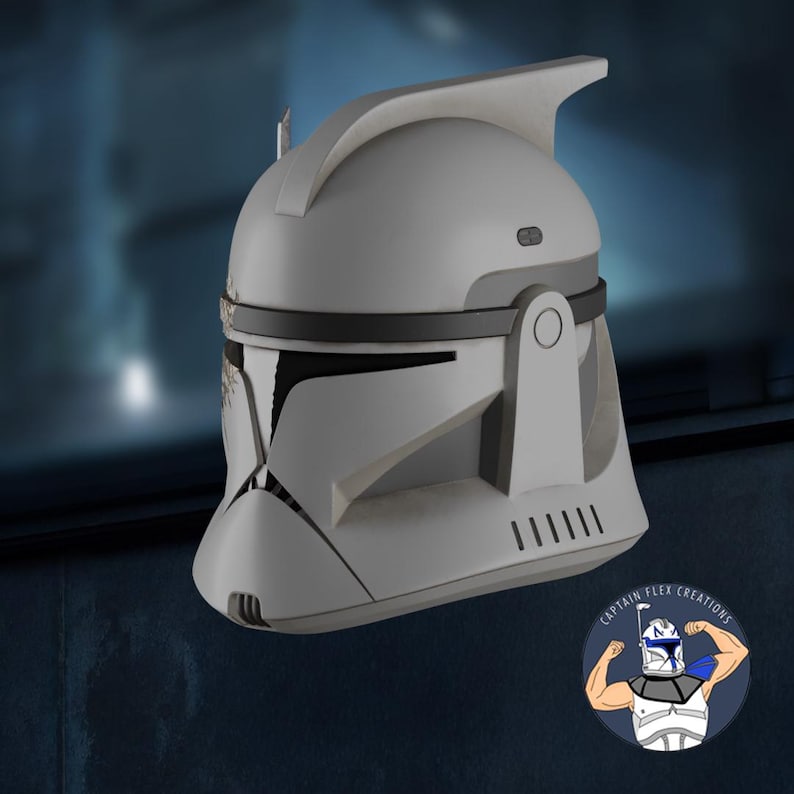 May include: A white and gray helmet with black accents, featuring a distinctive visor and ventilation slits. The helmet has a curved top and a detailed design, reminiscent of a science fiction theme.