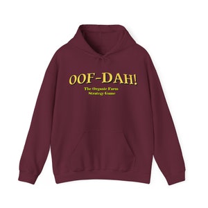 May include: A maroon hoodie with a yellow graphic that says "OOF-DAH! The Organic Farm Strategy Game"