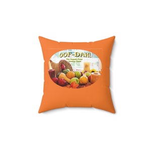 May include: Orange throw pillow with a white oval graphic featuring a cornucopia filled with fall fruits and vegetables. The graphic also includes the text "Oof-Dah! The Organic Farm Strategy Game".
