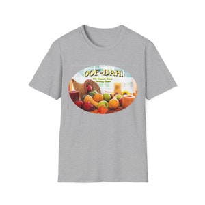 May include: A gray t-shirt with a round graphic of a cornucopia filled with fall fruits and vegetables. The graphic has the text "Oof-Dah! The Iroquois Farm Strategy Game" in yellow.