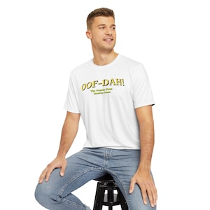 May include: White t-shirt with a yellow graphic that says "OOF-DAH! The Organic Farm Strategy Game"