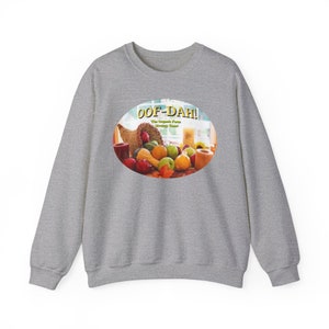 May include: A gray sweatshirt with a round, colorful image of a cornucopia overflowing with fruit and vegetables. The image has the text "Oof-Dah! The Organic Farm Strategy Game" in yellow letters.