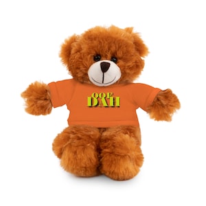 May include: A brown teddy bear wearing an orange t-shirt with the text "OOF DAH" in yellow.