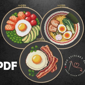 May include: Three cross stitch patterns featuring different food dishes: a bowl of ramen, a plate of eggs and bacon, and a bowl of avocado toast with salmon and tomatoes. The patterns are in black and white and are framed in wooden hoops. The text "MAX STITCHES ART CROSS STITCH PATTERNS" is visible in the bottom right corner.