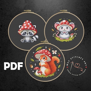 May include: Three cross stitch patterns featuring a raccoon, a mouse, and a squirrel, each wearing a red and white mushroom hat. The patterns are displayed in embroidery hoops on a dark background. The text "MAX STITCHES ART CROSS STITCH PATTERNS" is visible in the lower right corner.