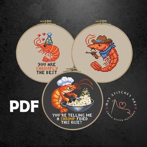 May include: Three cross-stitch patterns in embroidery hoops. One shows a shrimp with a party hat and the text "YOU ARE SHRIMPLY THE BEST." Another depicts a shrimp cowboy. The third shows a shrimp chef with the text "YOU'RE TELLING ME A SHRIMP FRIED THIS RISE?"