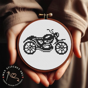 May include: Black and white cross stitch pattern of a motorbike in a round embroidery hoop.