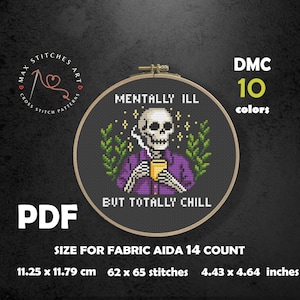 May include: Cross-stitch design in a hoop, showing a skeleton in a purple shirt, smoking and holding a coffee cup. Text reads "Mentally Ill But Totally Chill." Includes size details: 11.25 x 11.79 cm.
