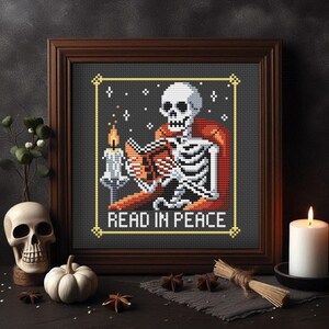 May include: A cross-stitch pattern featuring a skeleton reading a book by candlelight. The skeleton is wearing a red robe and is sitting in a chair. The text "Read in Peace" is below the skeleton.