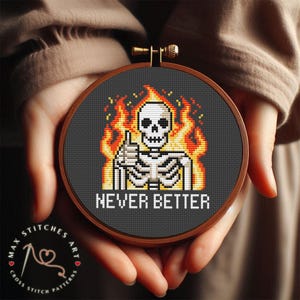 May include: A cross stitch pattern featuring a pixelated skeleton with a thumbs up, engulfed in flames. The text "Never Better" is below the skeleton.