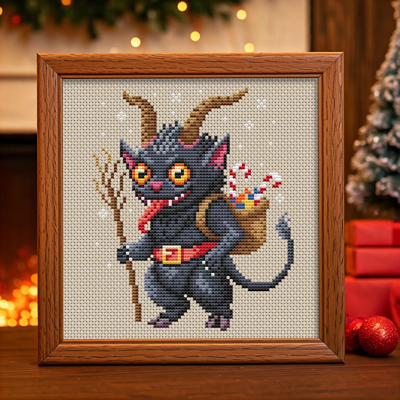 May include: A cross-stitch pattern of a black, horned, cartoon creature with a red belt and a sack of candy canes on its back. The creature is holding a stick in its right hand and has a long tongue sticking out. The background is a light beige with a snowflake pattern.