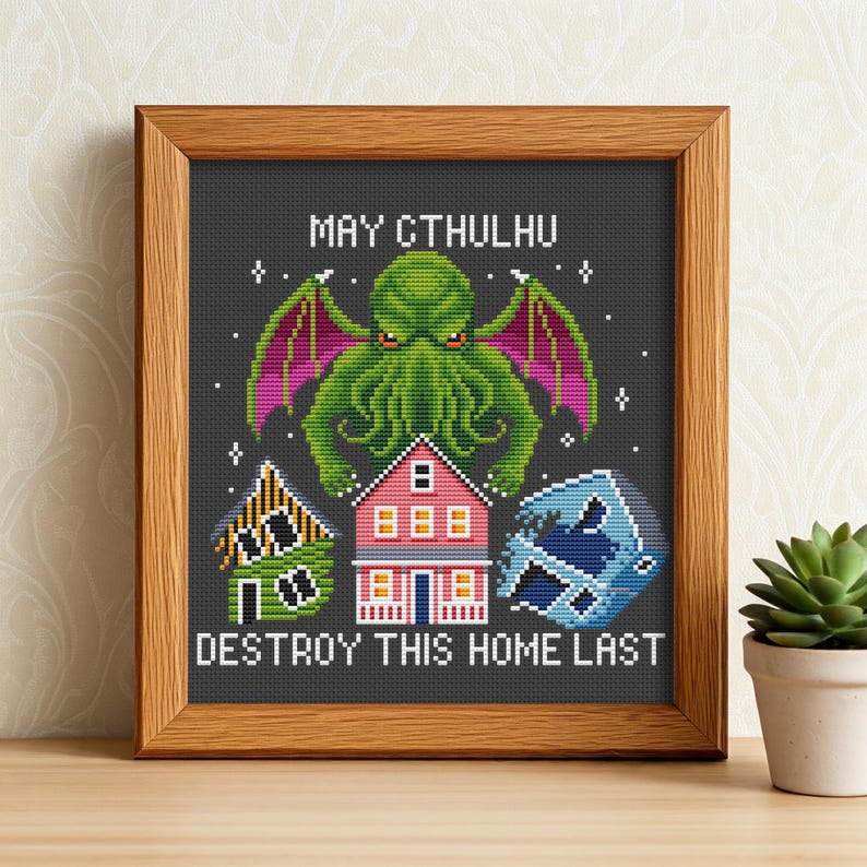 May include: Cross-stitch pattern featuring a green Cthulhu monster with the text "May Cthulhu Destroy This Home Last". The pattern also includes a pink house, a yellow house, and a blue wave.