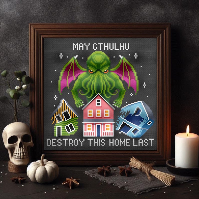 May include: A cross-stitch pattern featuring a green, tentacled monster with red wings, labeled "May Cthulhu Destroy This Home Last". The monster is positioned above three houses, one green, one pink, and one blue.