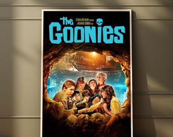 May include: A movie poster for The Goonies featuring the title in large light blue letters at the top with a skull icon. The artwork depicts a group of children inside a dark cave looking at a map, with a pirate ship visible in the background.