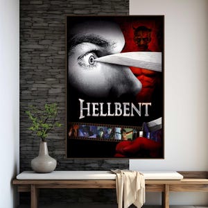 May include: A framed movie poster for "Hellbent" featuring a close-up of an eye with a knife, a red devil figure, and the film's title. The poster has a dark, dramatic aesthetic, with a film strip at the bottom.