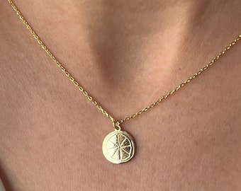 May include: A gold chain necklace with a small, round pendant featuring a detailed lemon slice design.