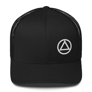 May include: Black trucker hat with a white embroidered triangle within a circle logo on the front. The hat features a mesh back and a curved brim. A classic and versatile accessory.