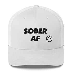 May include: White trucker hat with black embroidered text that reads "SOBER AF" and a black triangle symbol.