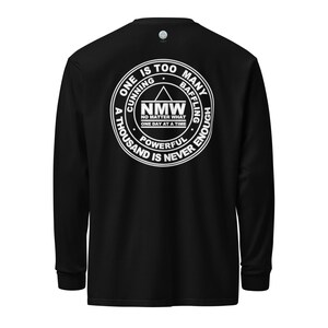 May include: Black long-sleeve shirt with a white circle graphic on the back. The graphic features the text "ONE IS TOO MANY", "CUNNING", "BAFFLING", "A THOUSAND IS NEVER ENOUGH", "POWERFUL", and "NMW NO MATTER WHAT ONE DAY AT A TIME".