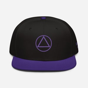May include: A black and purple baseball cap with a purple triangle inside a circle on the front. The cap has a purple brim.