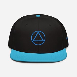 May include: A black and blue baseball cap with a blue triangle inside a circle on the front. The brim of the cap is blue.