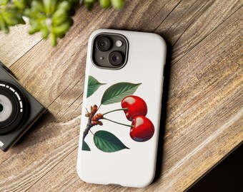以下が含まれることがあります： 赤いチェリーのイラストが描かれた白い携帯電話ケース。チェリーは緑色の茎と葉に付いています。
