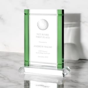 May include: A clear glass award with green accents. The award features the text "NET SCORE FIRST PLACE" and the name "ANDREW WALSH". The base is clear and faceted. A golf ball graphic is also present.